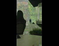 Woman dances in front of art exhibit 