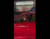 Driver plays maracas and blows kiss in car 