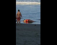 Girl lays down on beach