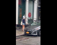 Woman walk street wear plastic bag on head