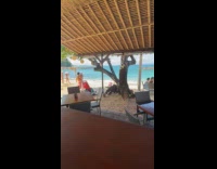 Woman beach attire with luggage at beach