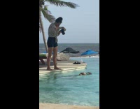 Bald woman feet over pool side tree