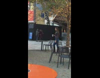 Woman hold drink near tree christmas lights