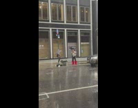 Guy continues to perform with trumpet in the rain