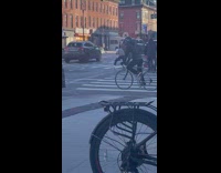 Guy shadowboxing while waiting to cross crosswalk