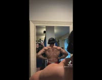 Bodybuilder guy wear dress flex muscles mirror