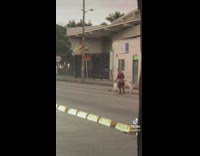 Woman crossing street holding dogs paw 
