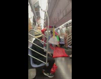 People hold fake met gala inside subway train