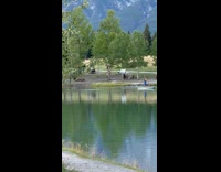 Woman in bikini pole dance near lake