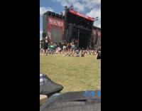 Woman in black top poses at the concert grounds