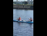 Two guys blue paddleboard orange life vest 