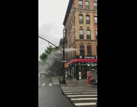 Person washes outside of apartment with hose