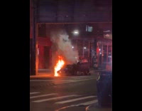 Car burning on the side of street