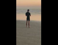 Blue surfboard on beach sand 
