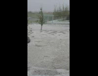 Hail storm floods street silver car neighborhood