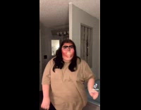 Girl with unibrow and red face mask on dancing 