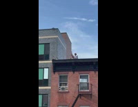 Guy does peace sign from rooftop 