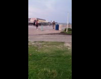 Guy skateboard tank top beach trash bin