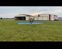 Guy blue parachute white helmet fail grass