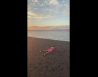 Kid pink clothes takes couple  photo beach 