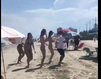 White shirt guy and bikini girls dance