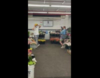 Guy poses at flower market with arms up