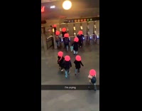 Group of women wear matching pink wigs 