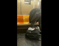 Guy wipes down orange subway train seat