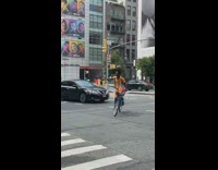 Collab winy - Guy balances ball while riding bicycle around intersection