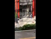 Black shirt girl red building entrance tripod 