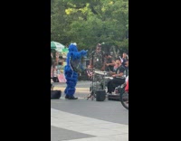 Fake cookie monster dancing next to band