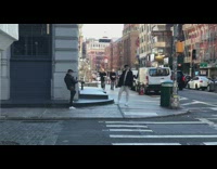 Guy poses for picture at corner of street sidewalk
