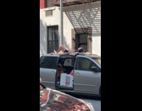 Man shirtless lie down roof of car