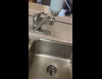 Girl removes sink filter for more water 