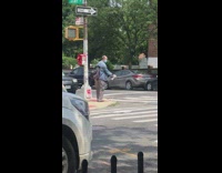 Guy sprays air with purifier while crossing street 