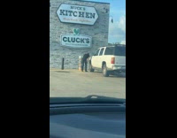 Man pumps air to car tire manually 
