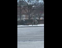 Man twerk dance on the snowy sidewalk