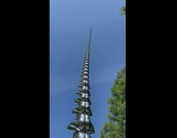 Statue of people stacked high on each other 