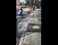 two girls orange sweater sit sidewalk