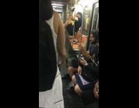 Man tucks in legs and does pull ups on subway handrails