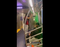 Guy enters train carry large painting canvas