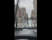 Lady uses broken umbrella while walking outside