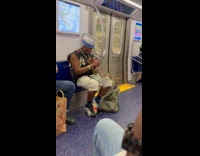 Man with pet snake on chain necklace on subway