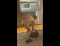 Naked man with cloth covering his penis waits at subway station