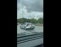 Silver car on freeway driving with broken bumper