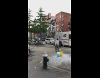 man in grey making giant bubbles another man in ambulance