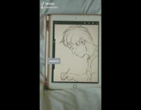 Girl draws boy on tablet paint