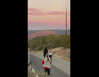 Man black hoodie walk middle road sunset