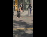 Woman sweep flowers with wind chimes at the street