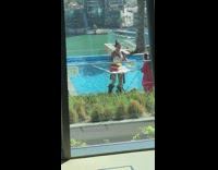 Woman in a shiny outfit pretends to be a DJ